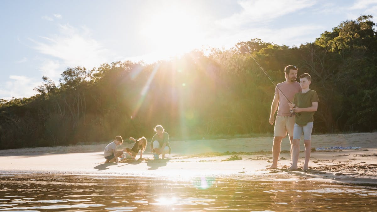 Family fishing and enjoying the outdoors on Coochiemudlo Island beach, Redlands Coast
