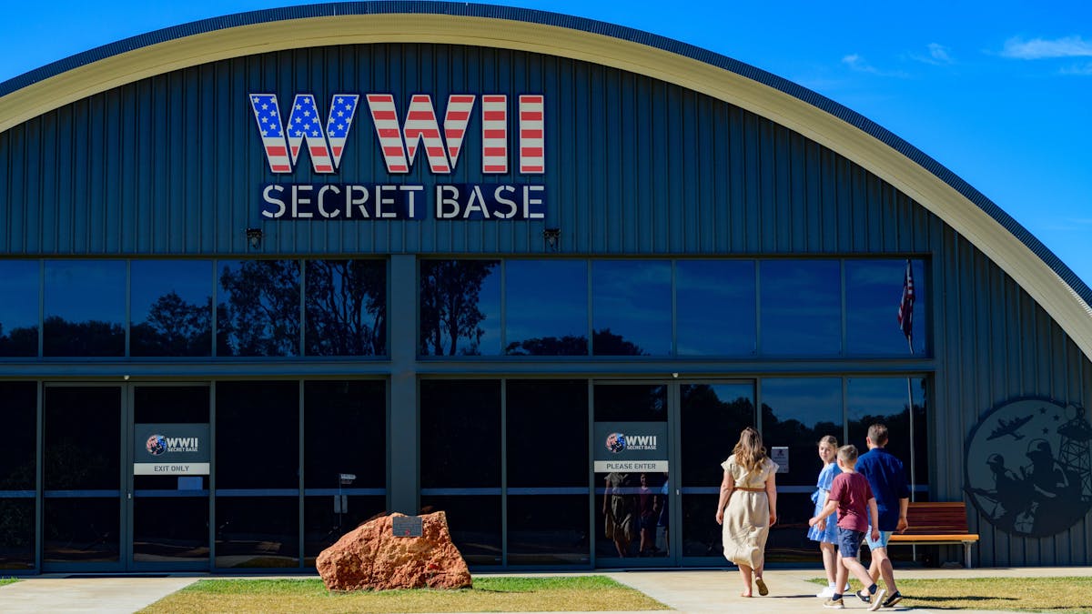 Front entrance of the base with a family of four walking towards the front entrance on a clear day
