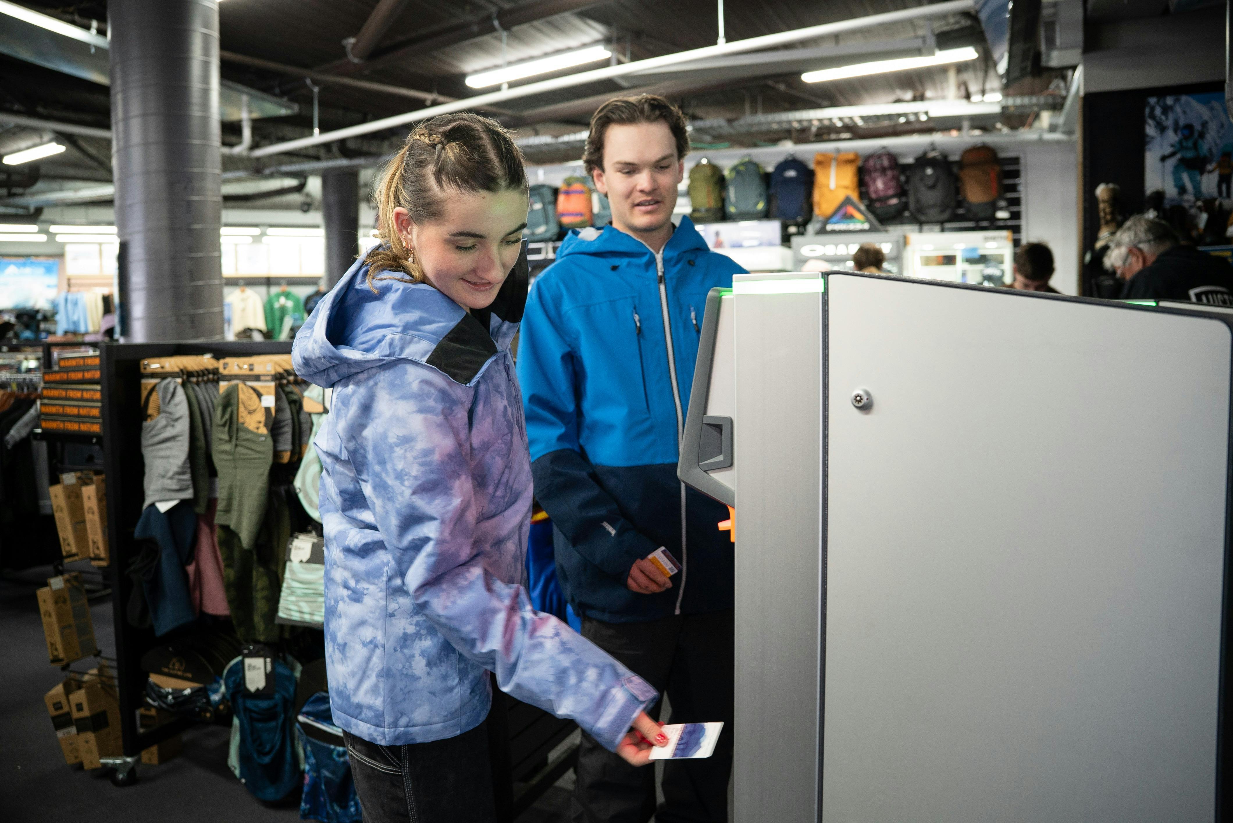 Couple collecting their lift tickets