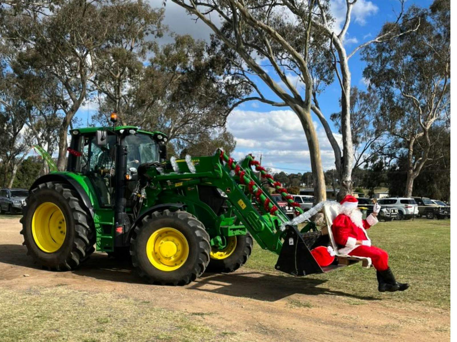 Santa arriving in a tractor bucket