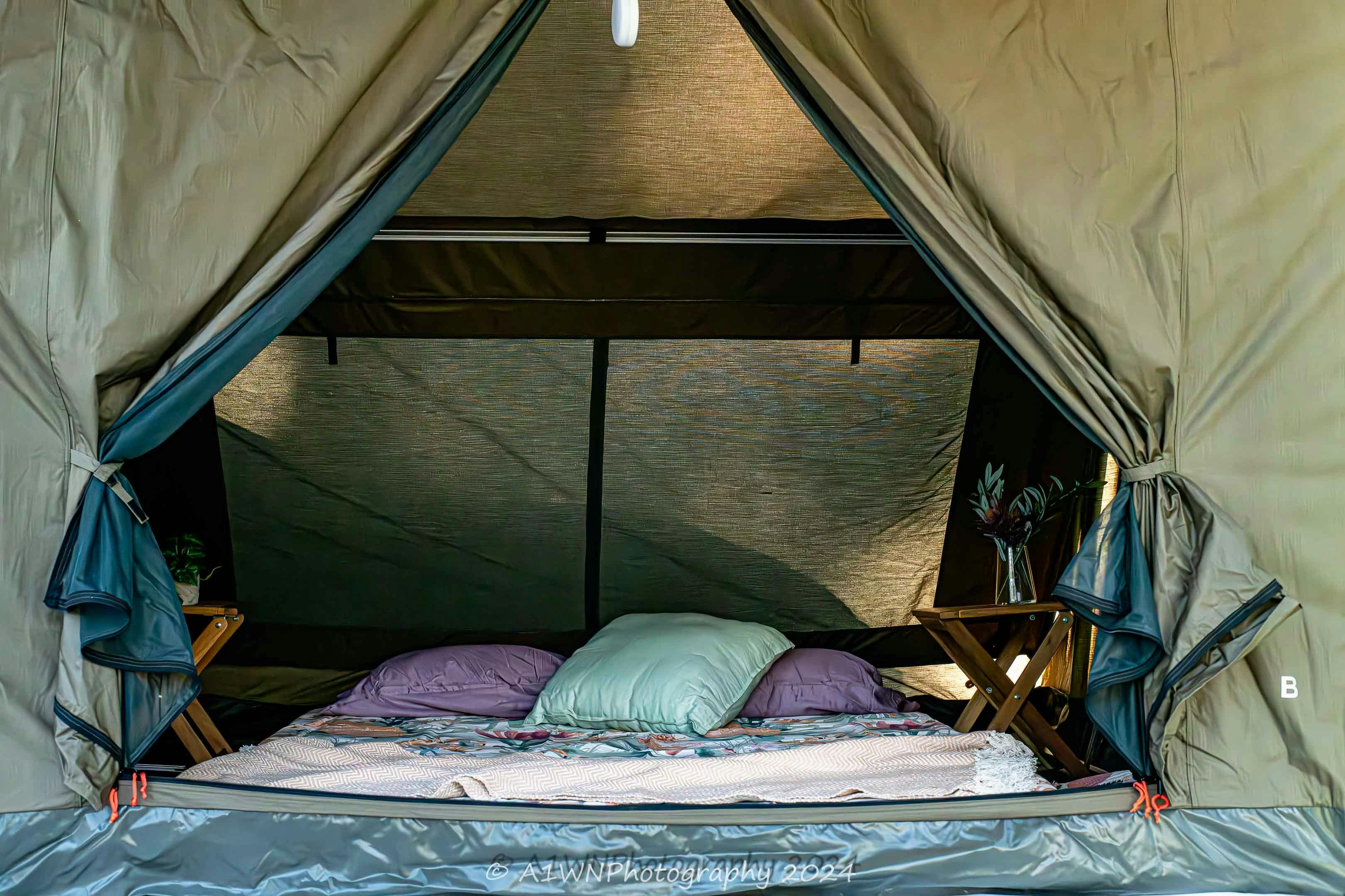 Comfortable double bed in a safari tent