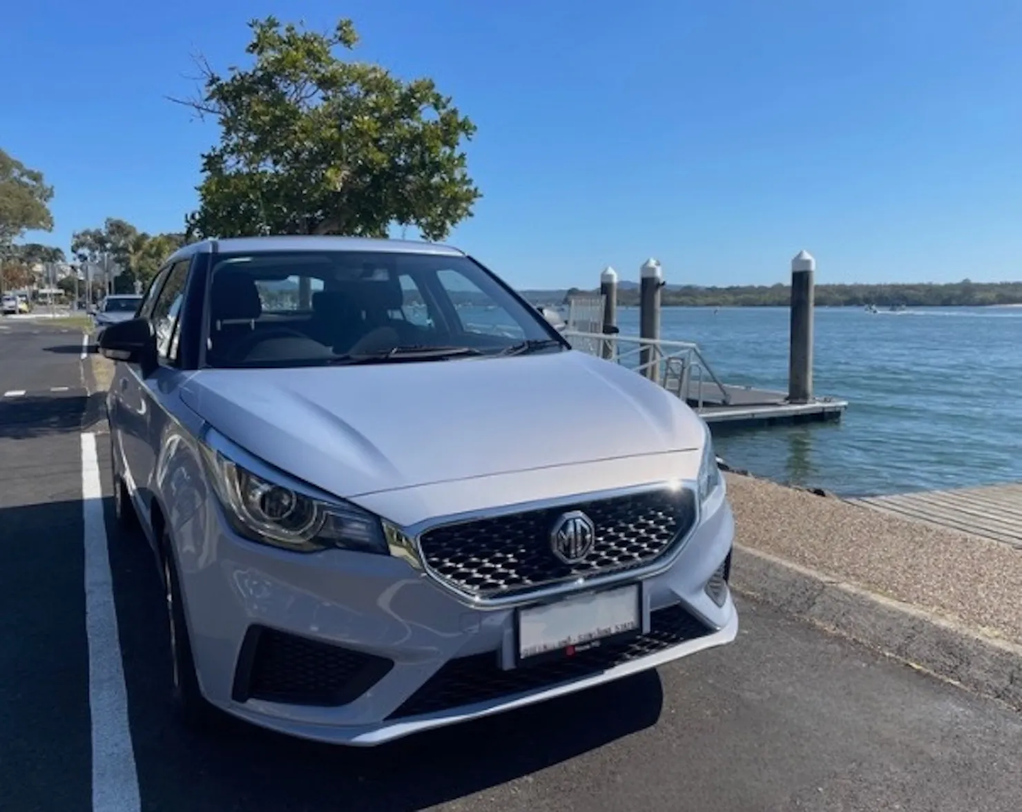 RentaCar Noosa MG3 hatchback parked beside the Noosa River