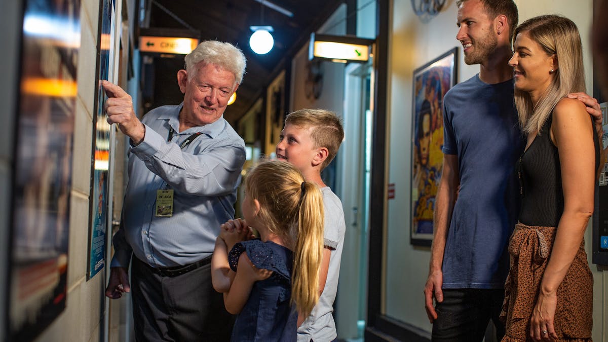 Cinema owner Ben joyfully interacting with a family