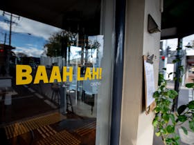 Front window, with decals in yellow 'BAAH LAH! Dining