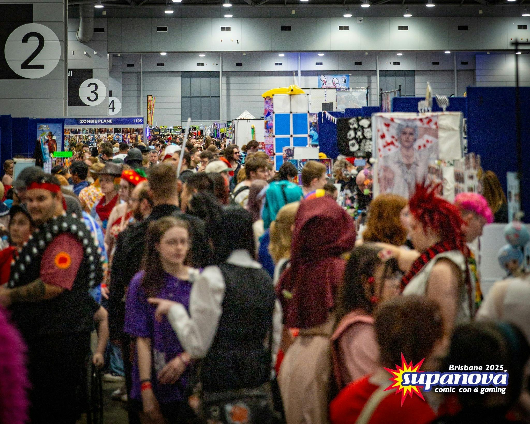 Crowded Supanova exhibition hall filled with fans and stalls.