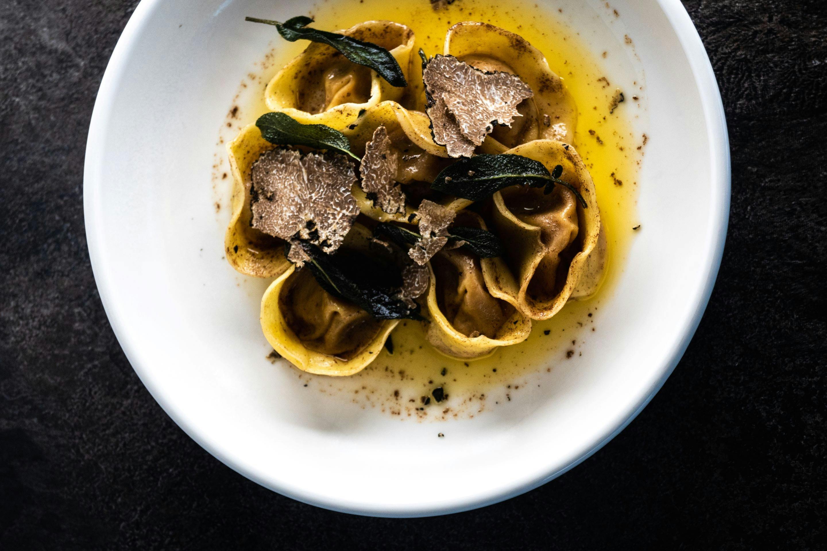 Homemade tortellini displayed with fresh truffle