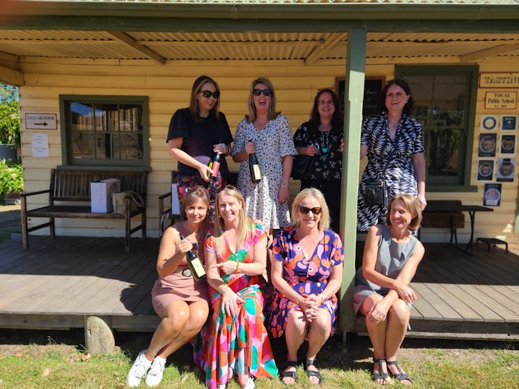 Group of lovely ladies posing with bottles of wine at Helm Wines
