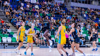 UC Capitals player driving to the basket for a layup during a WNBL game.