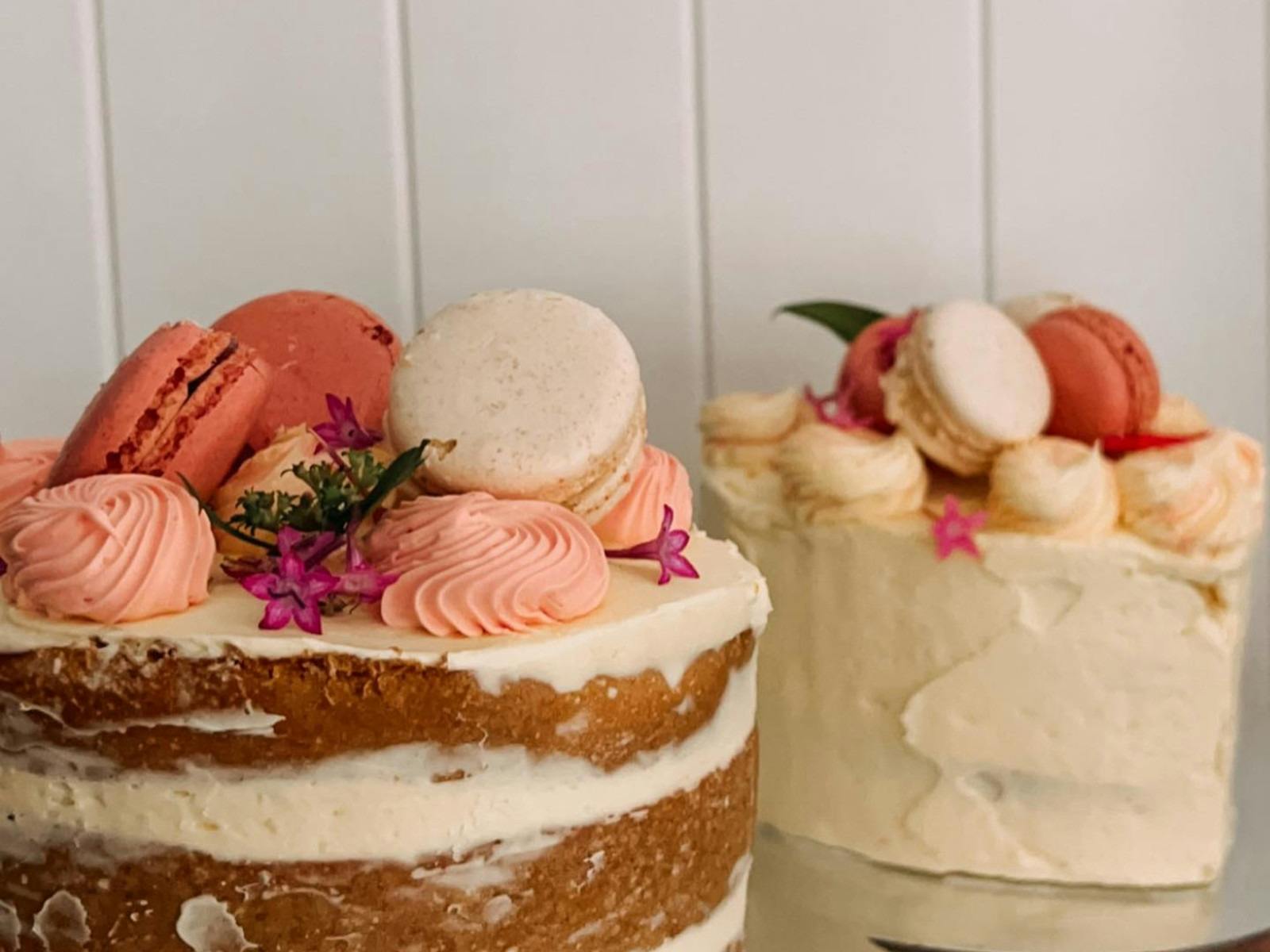 homemade cakes decorated with pink macaroons and flowers