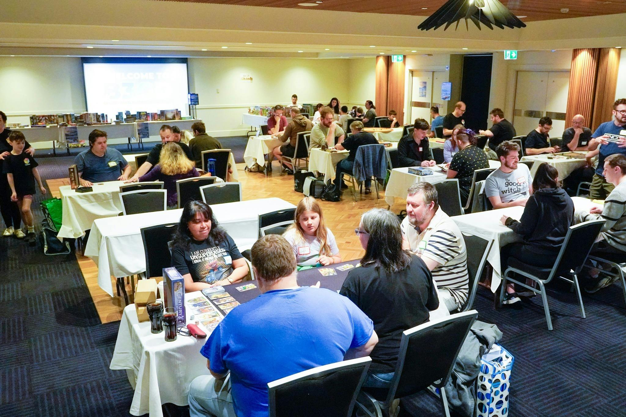 Our previous event - showing the tables and people playing games.