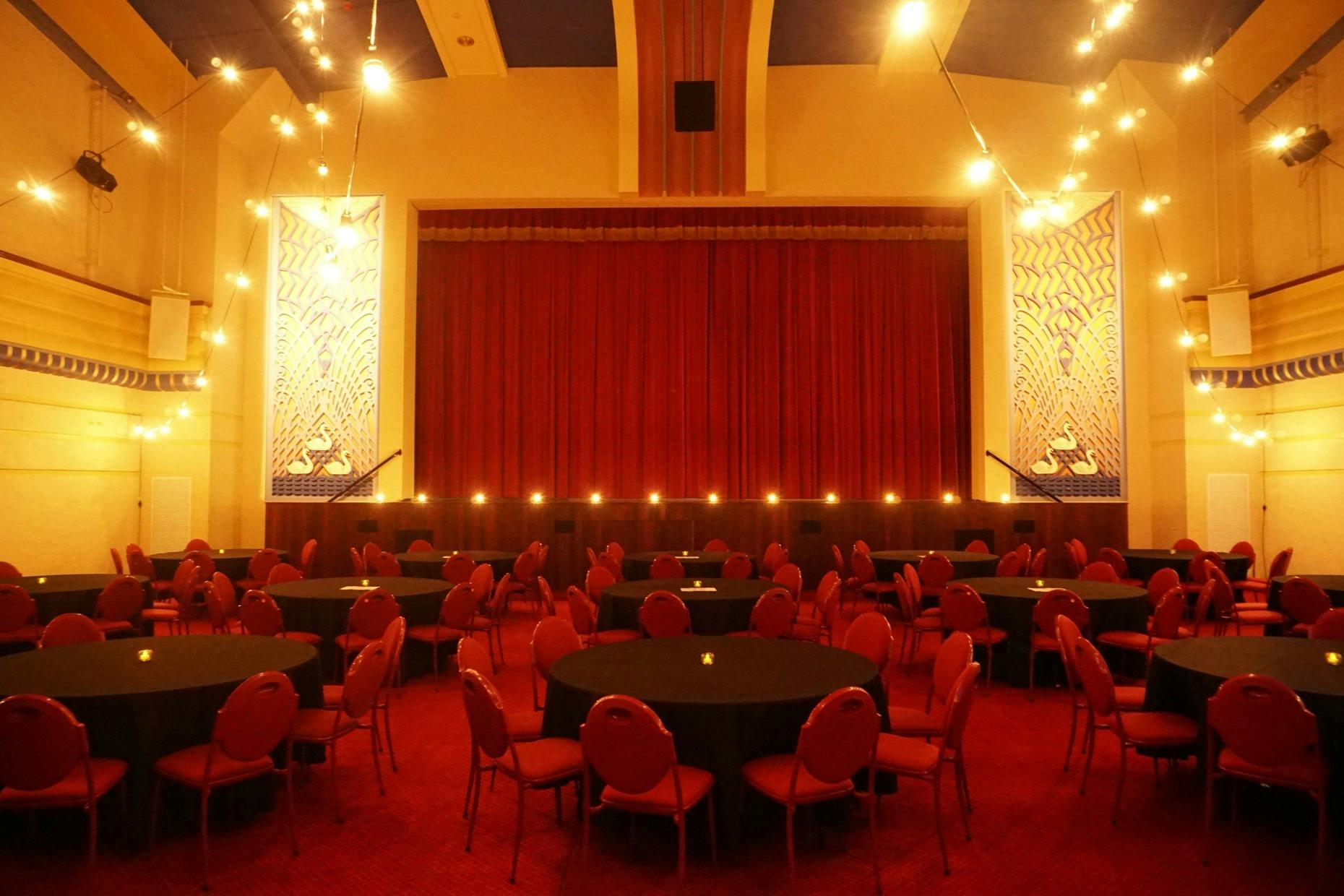 red chairs around black tables inside Swan Hill Town Hall