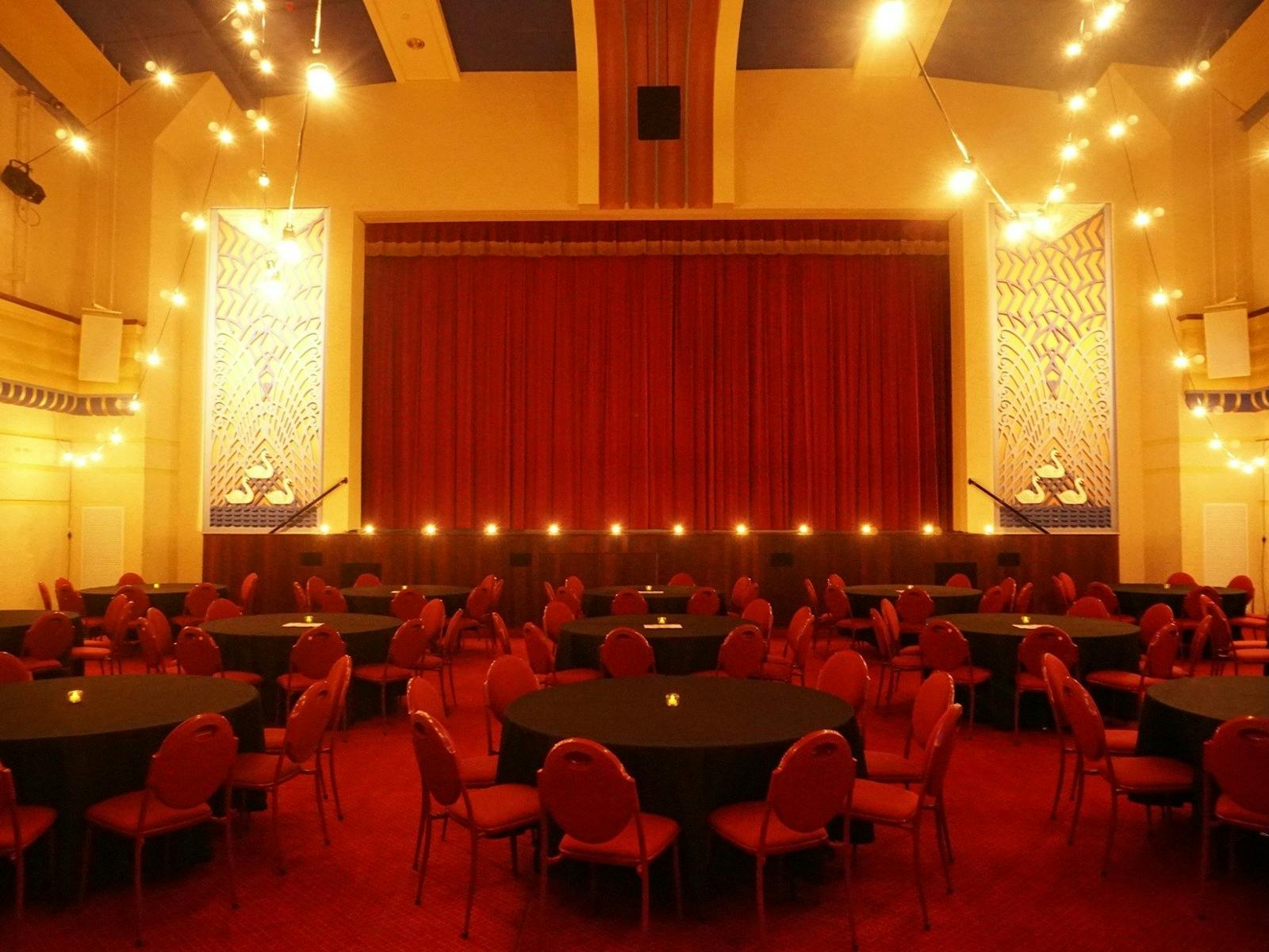 red chairs around black tables inside Swan Hill Town Hall