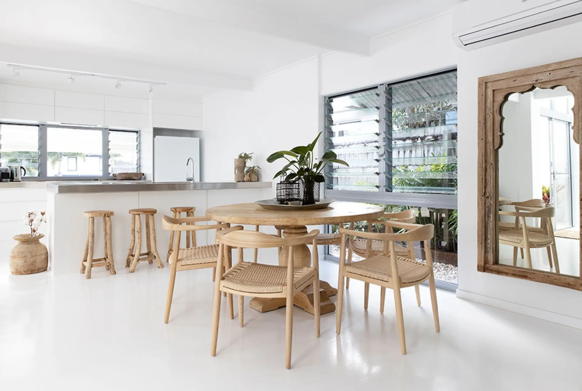 Open plan dining and living, with 6 seater round timber dining table for relaxed entertaining.