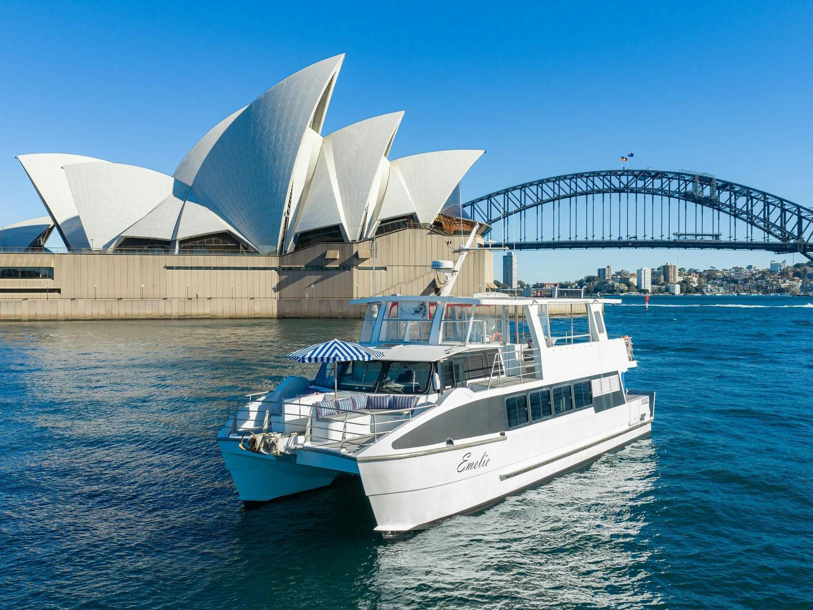 Capri on Emelie catamaran cruising past the Sydney Opera House and Harbour Bridge