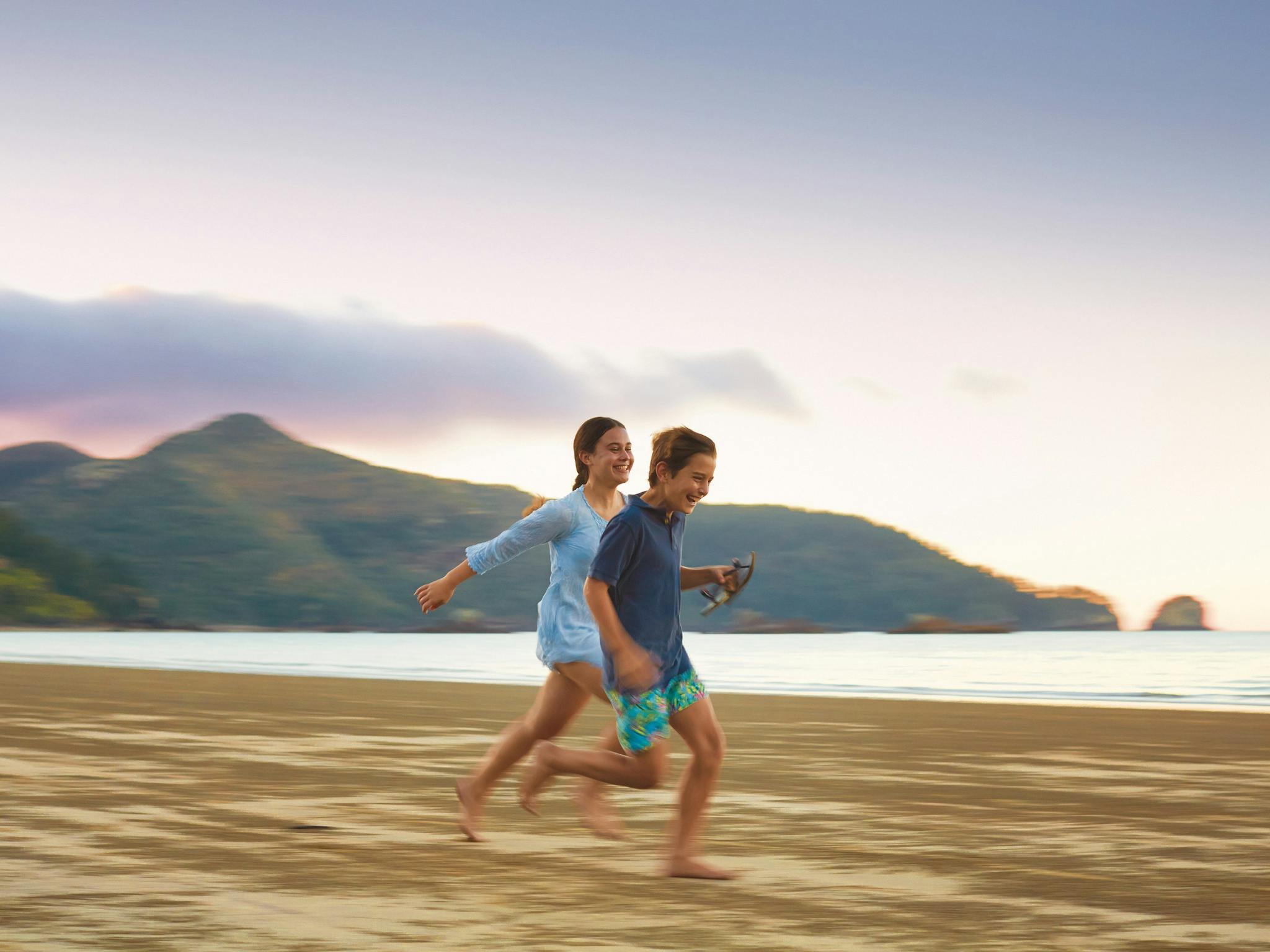 Kids running along Cape Hillsborough beach