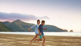 Kids running along Cape Hillsborough beach