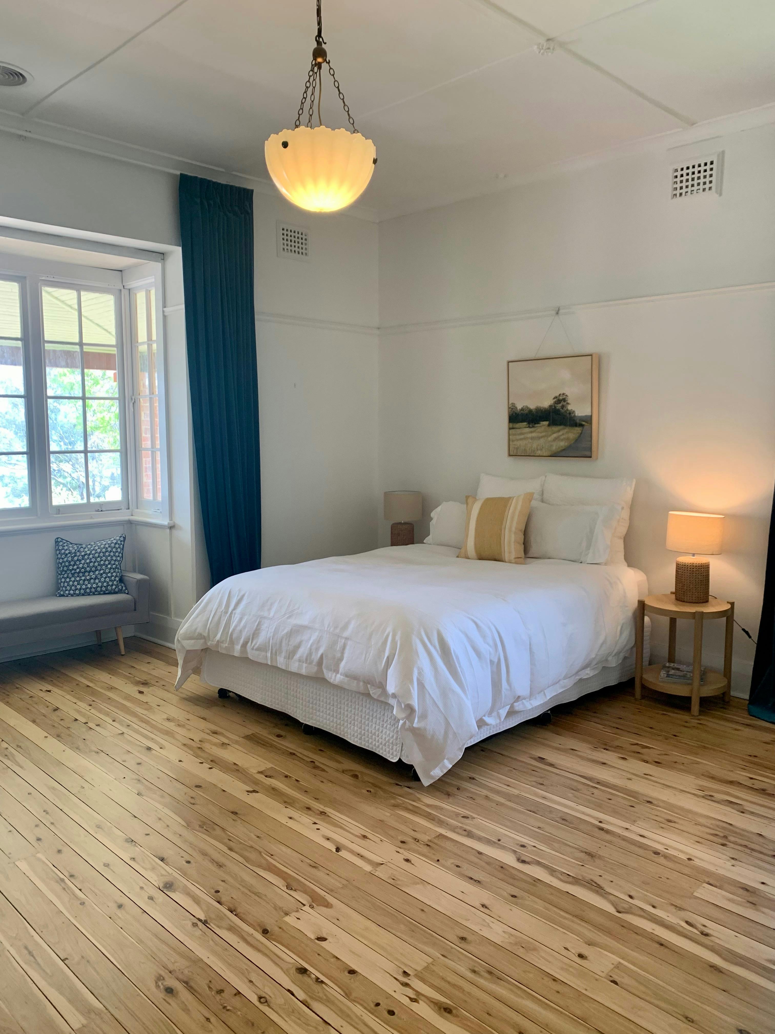 The room features a queen size bed, ceiling to floor velvet curtains and views over the pool.