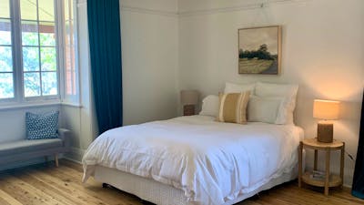 The room features a queen size bed, ceiling to floor velvet curtains and views over the pool.