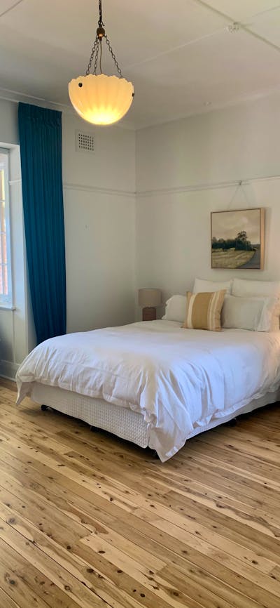 The room features a queen size bed, ceiling to floor velvet curtains and views over the pool.