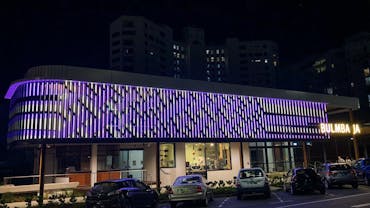 LED digital artwork facade in purple stripes by Aboriginal artist