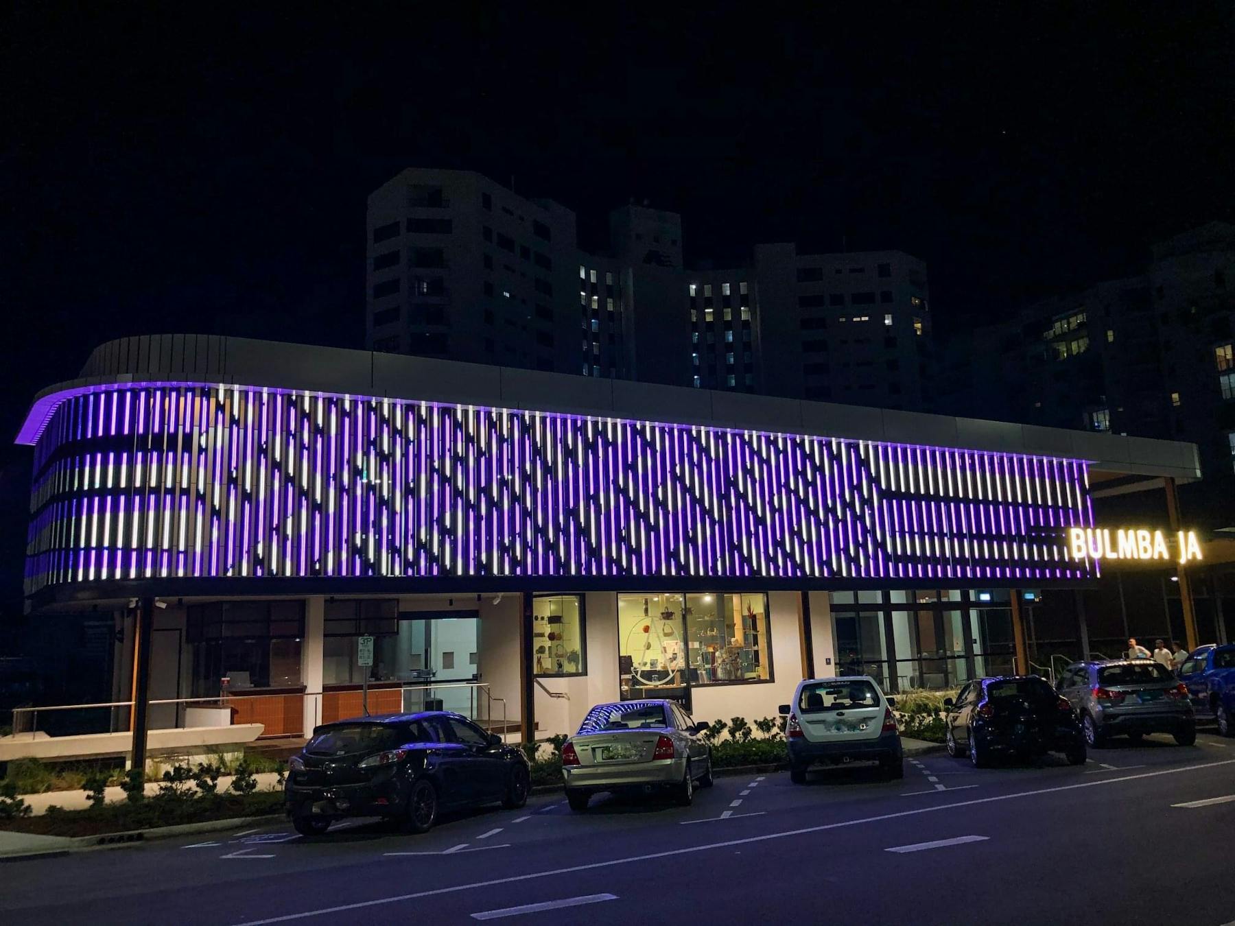 LED digital artwork facade in purple stripes by Aboriginal artist