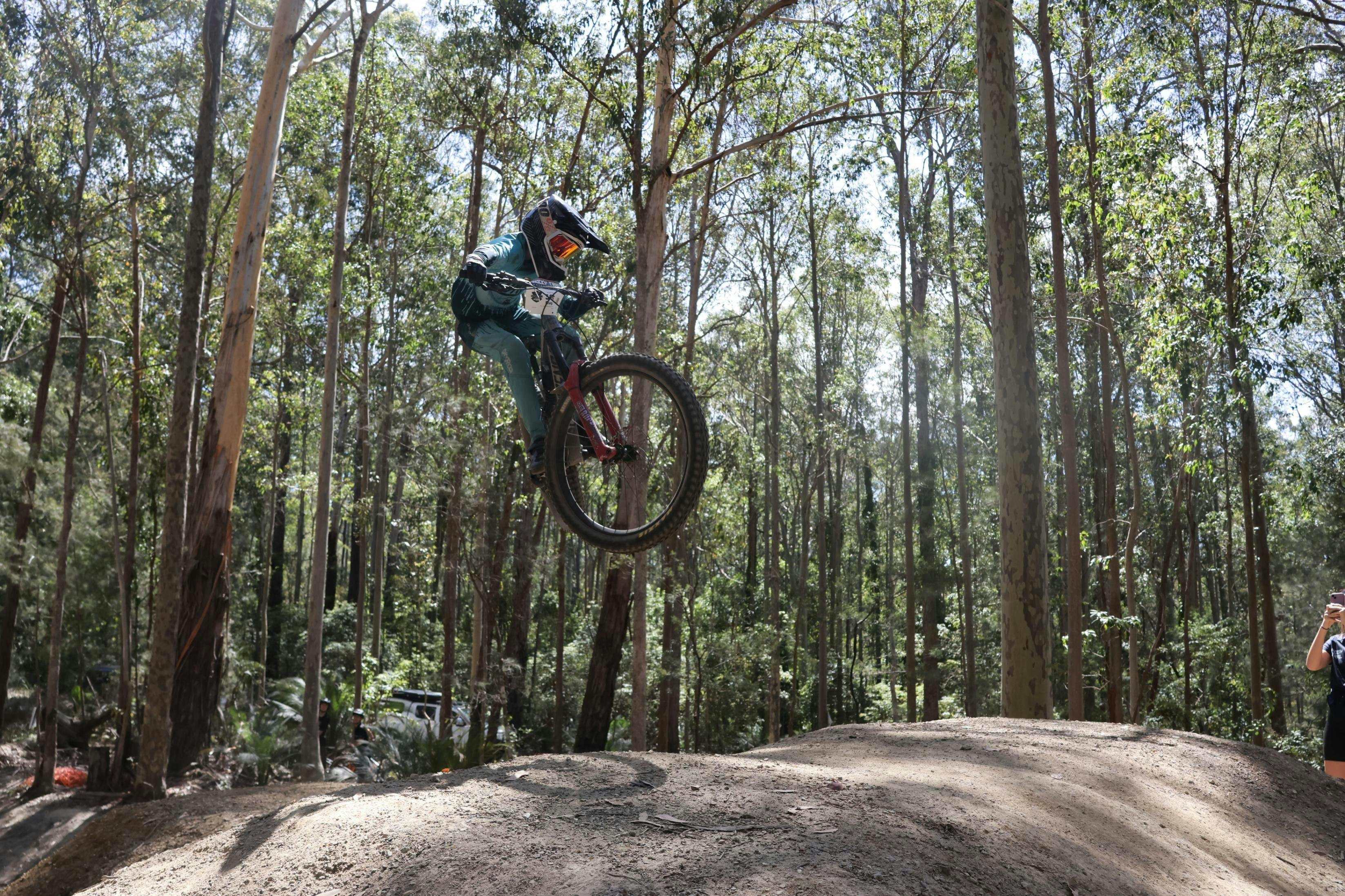 Cyclist taking a jump on Narooma Trails