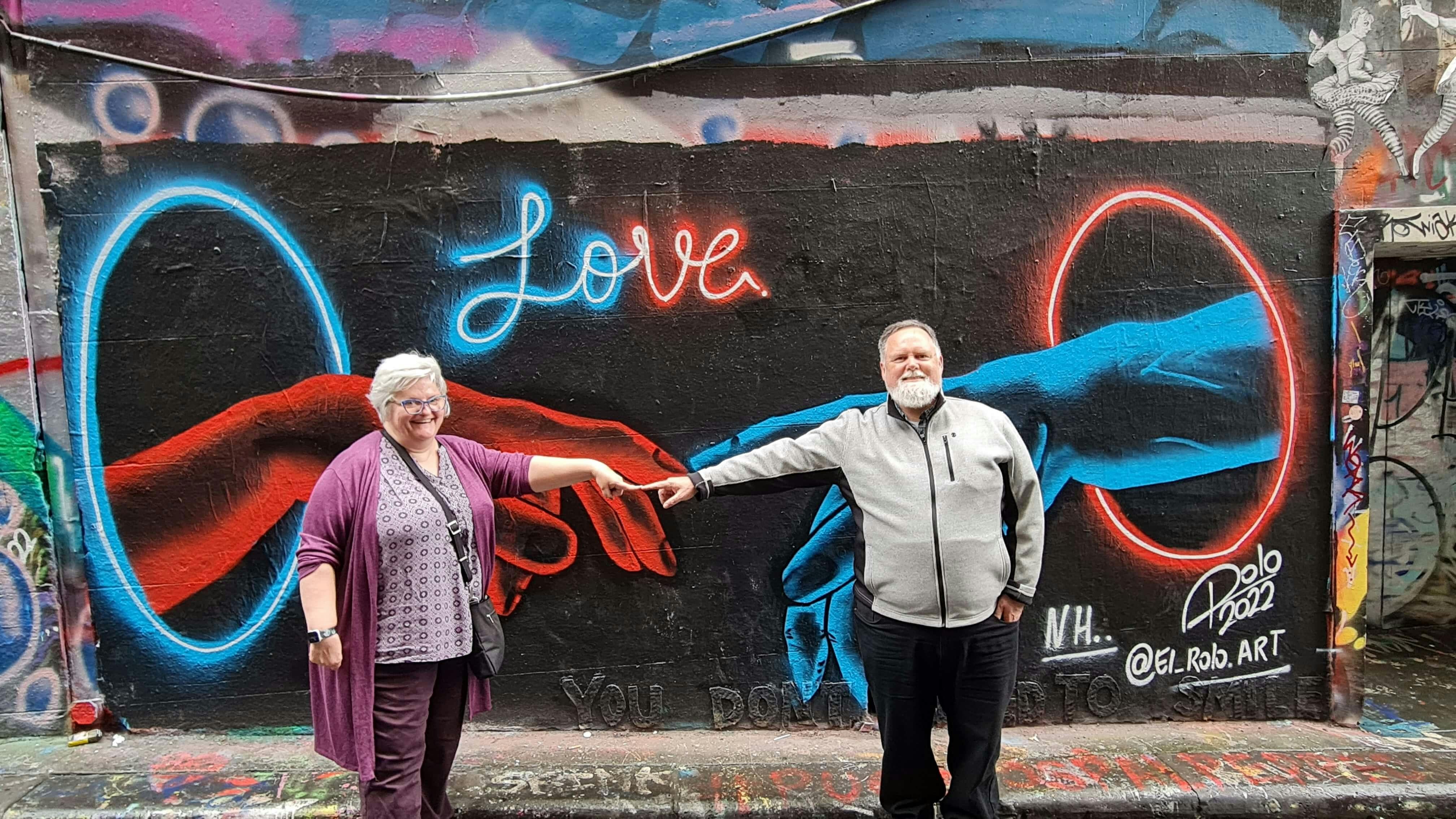 Couple posing with laneway art