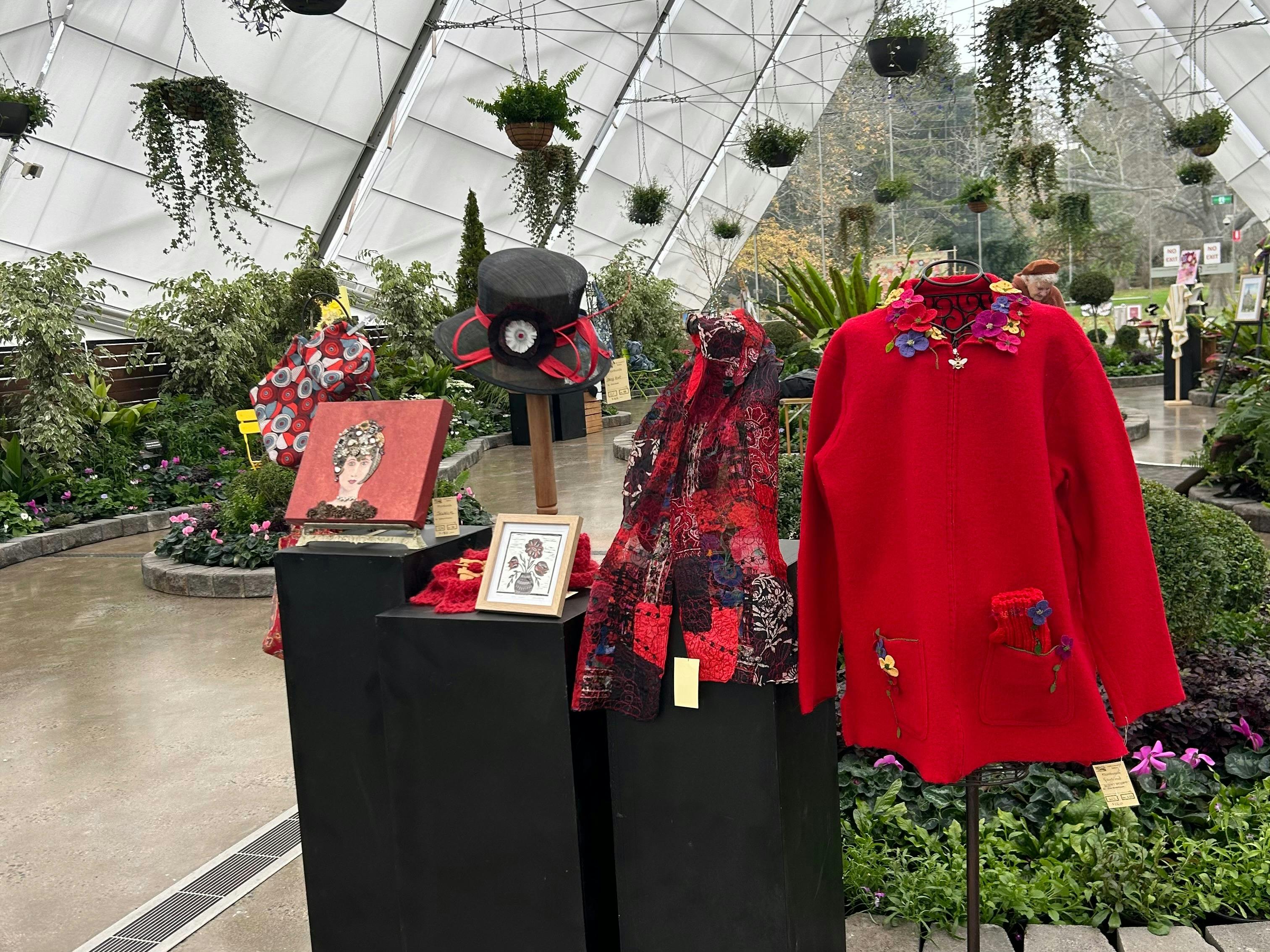 red coloured artwork and clothing on display
