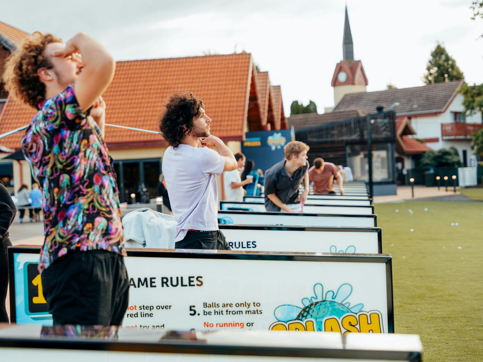 Men playing Splash Golf and admiring shots they have taken. Laughing having fun.