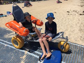 Accessible beach wheelchair on matting at Altona Beach
