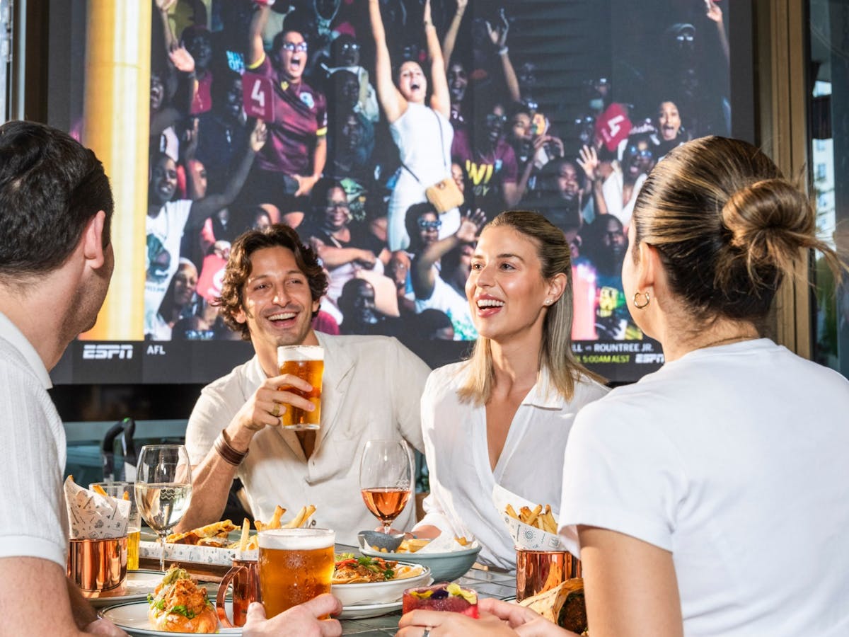 Customers enjoying food while watching sports