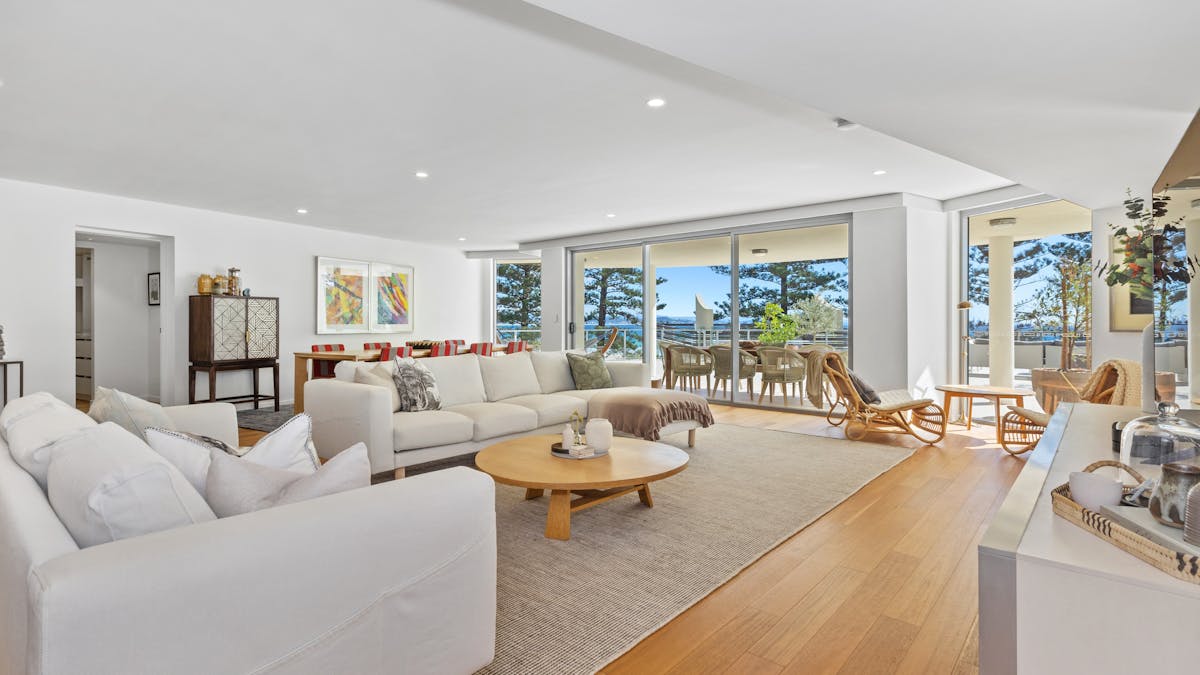 Spacious lounge in Apt 402 featuring timber floors, neutral sofas, chaise lounge, and ocean views. Spacious lounge in Apt 402 featuring timber floors, neutral sofas, chaise lounge, and ocean views.