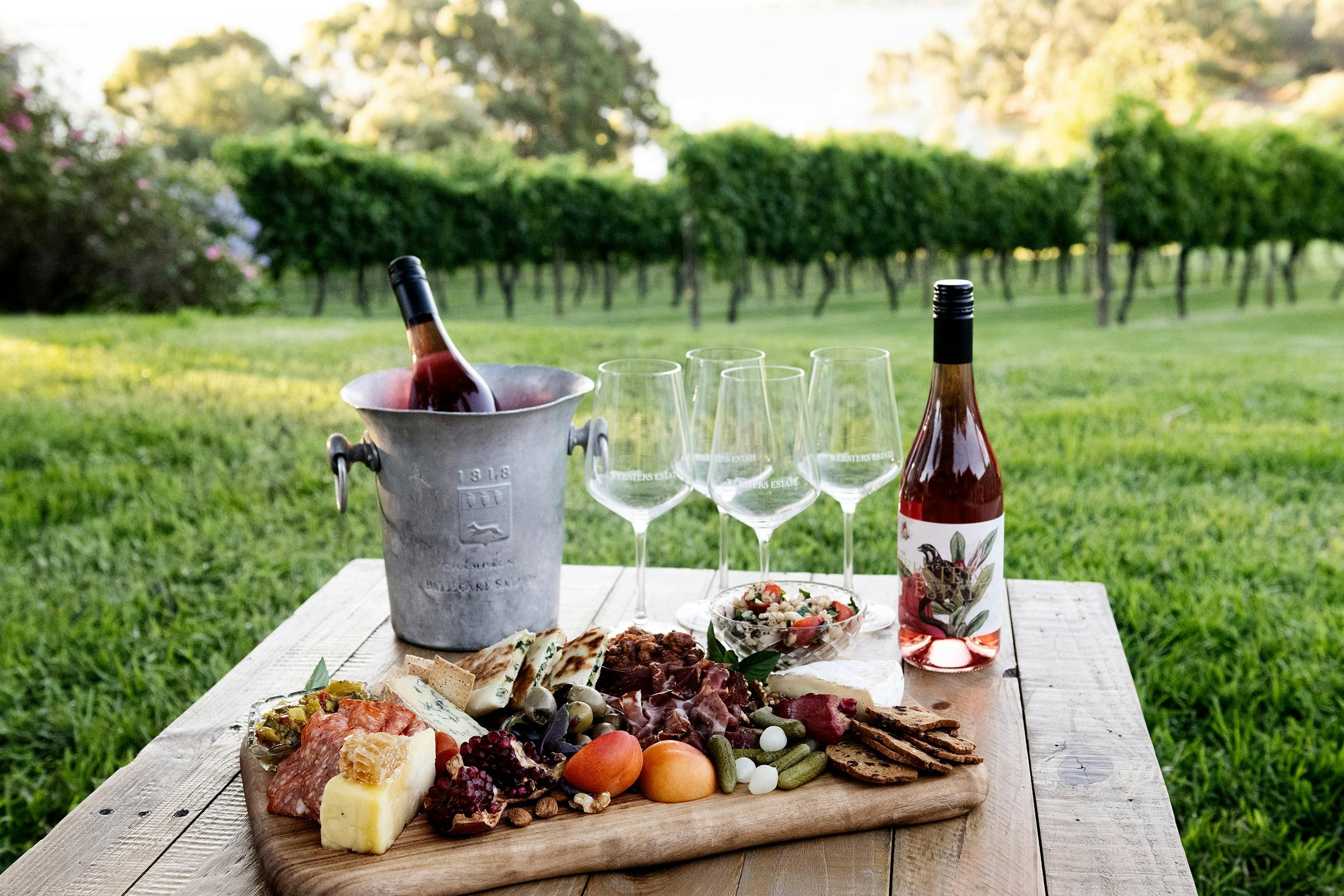 Wine and Grazing platter on a table by the vines