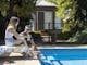 two people seated by the pool at The Brewer's House