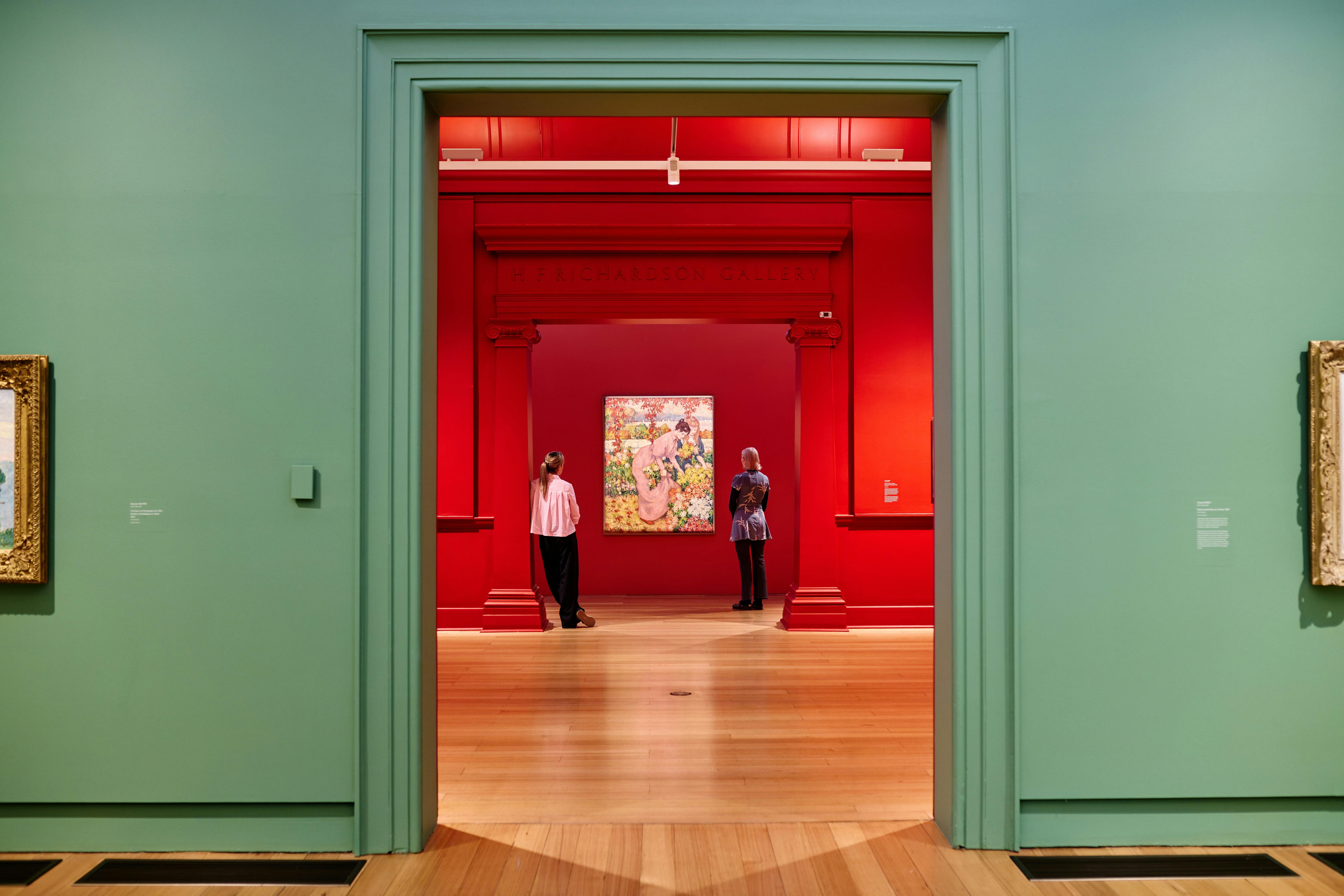 two visitors looking at an Impressionist artwork in gallery