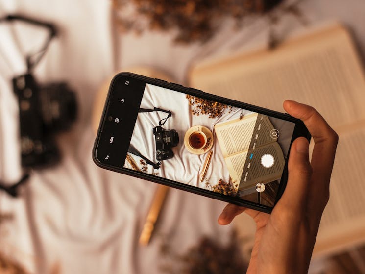 a smartphone camera taking a photo of a flat lay design