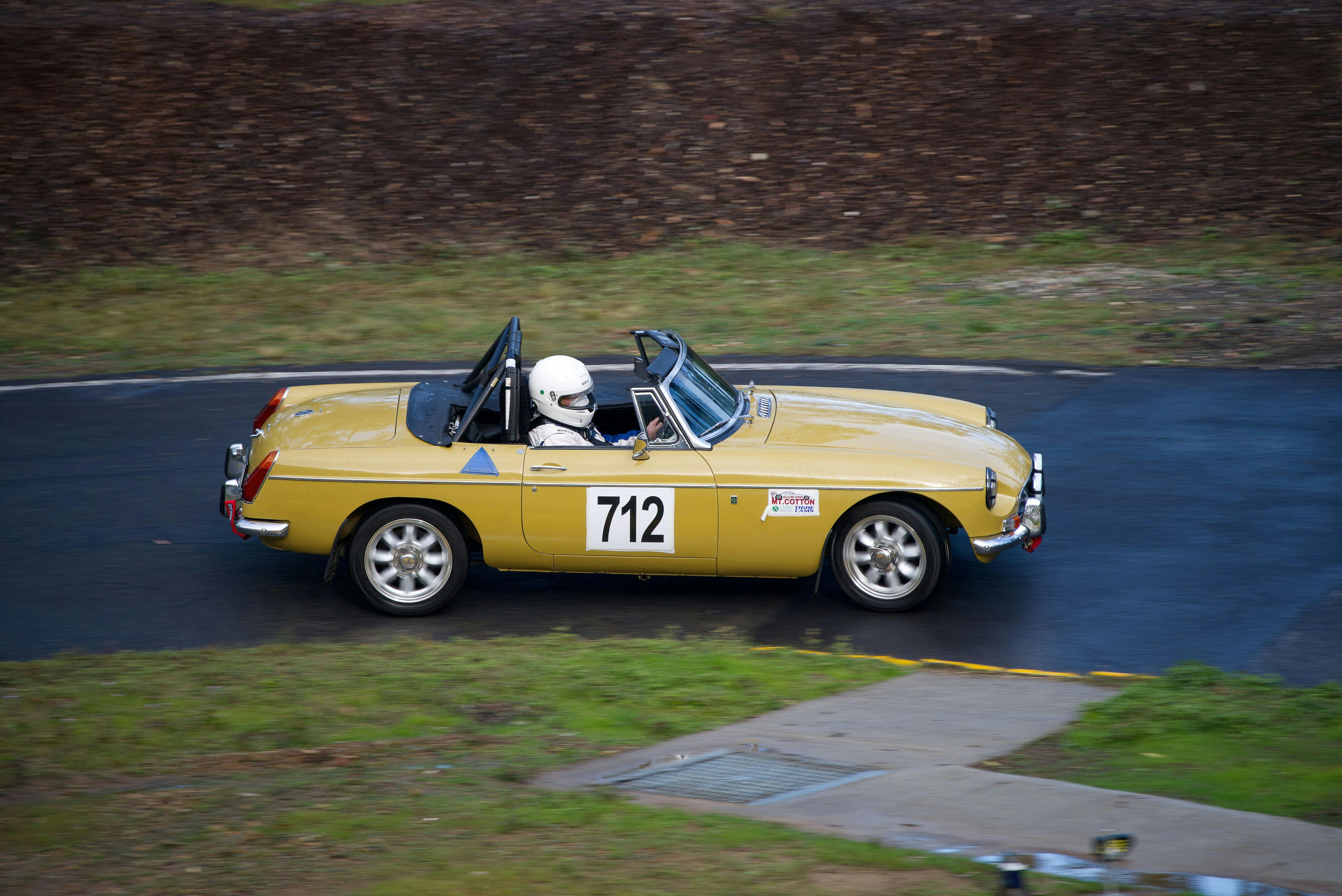 A driver competing in the Regularity class in their MGB negotiating the hairpin