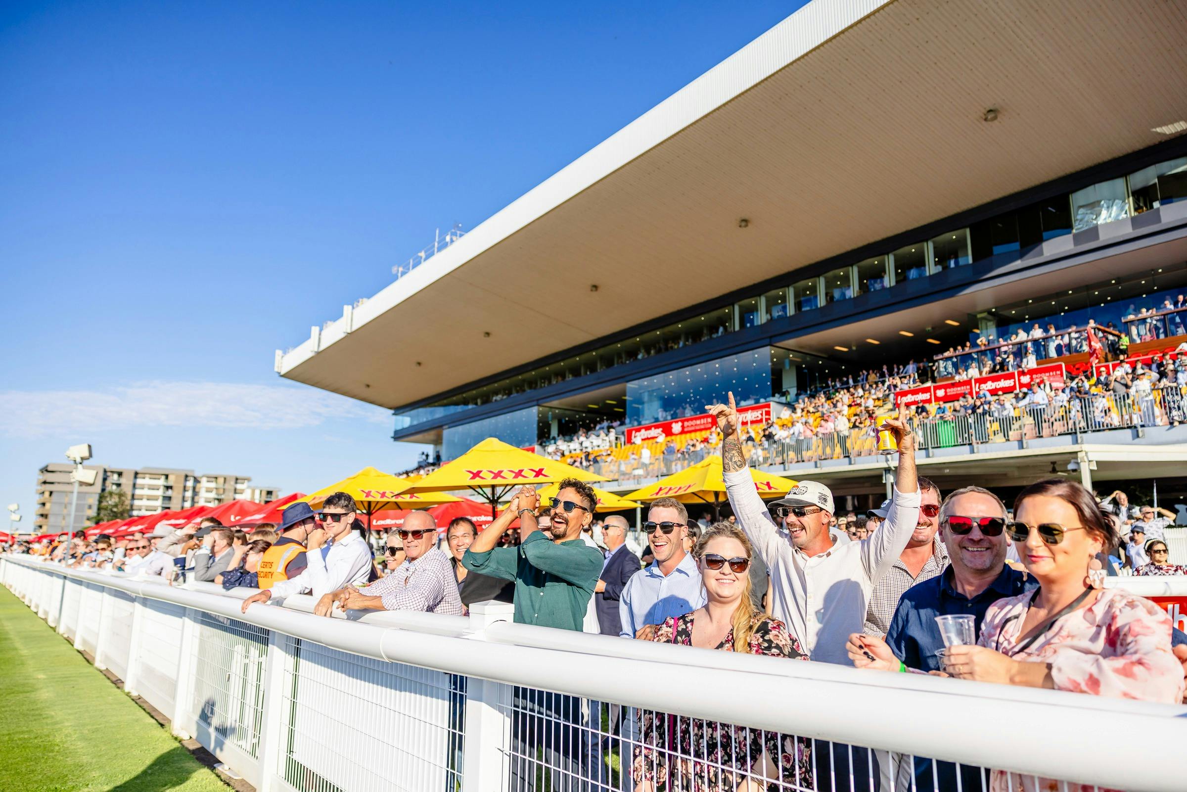 Racegoers celebrate trackside at Doomben Racecourse