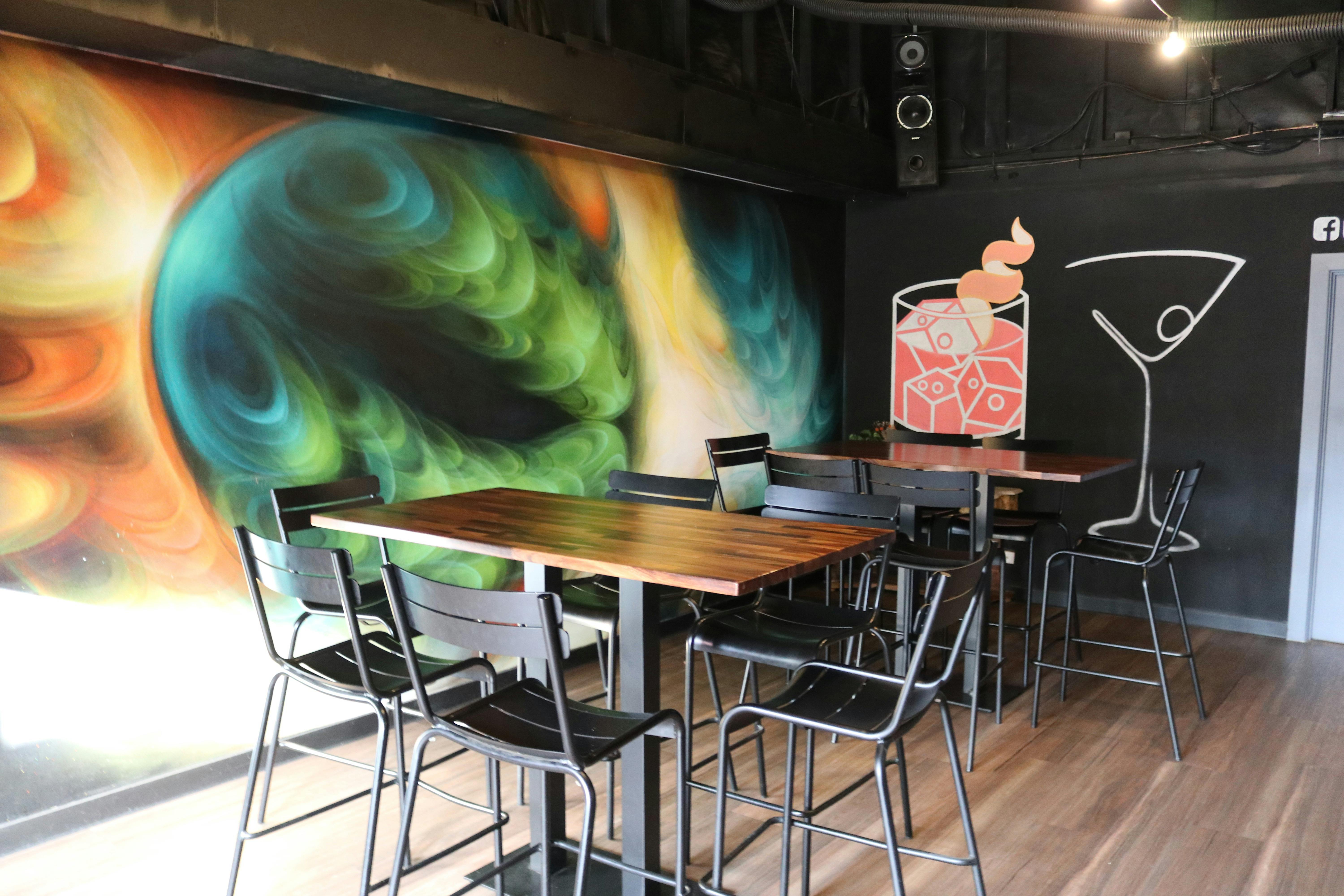 Outdoor area of a venue with umbrella and sign on the wall