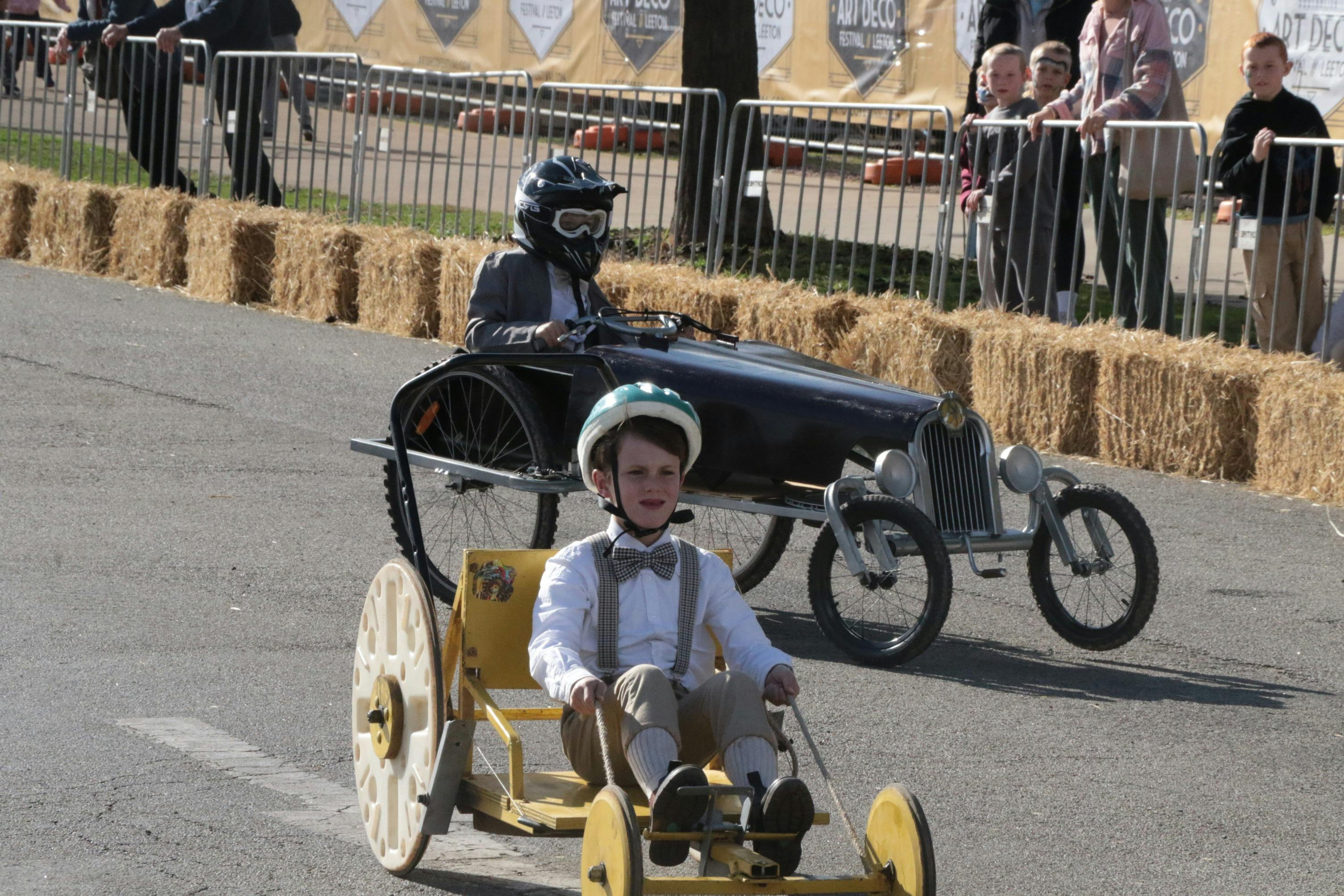 Soapbox Derby cart racing through the street during the Australian Art Deco Festival Leeton.