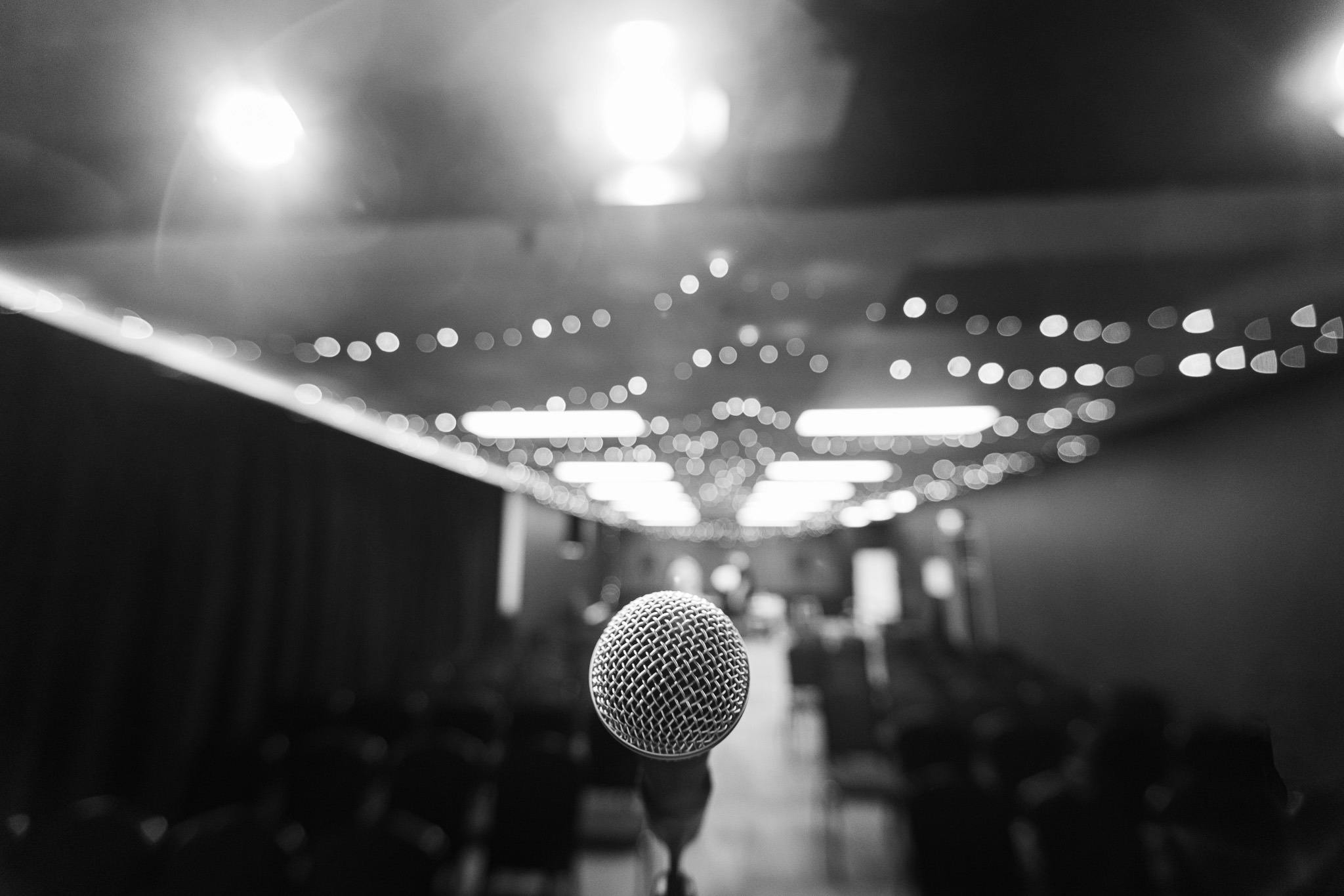 black and white image of a microphone pointed at the camera