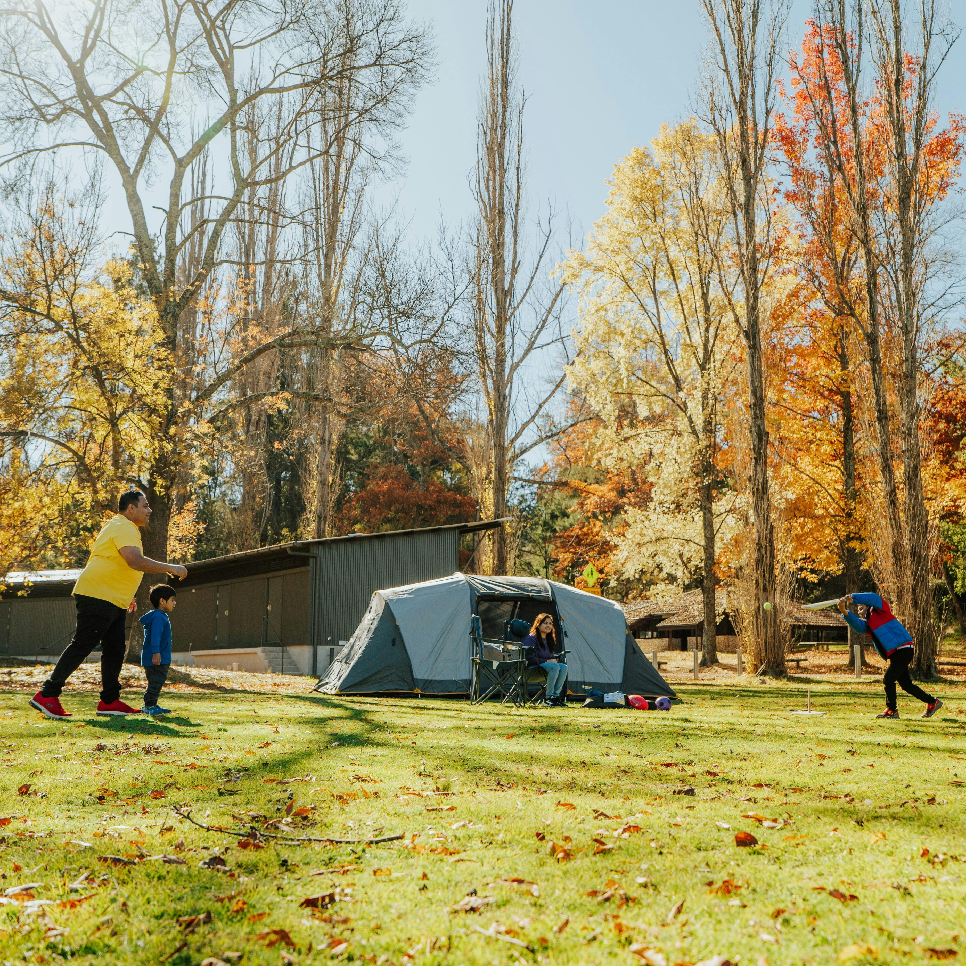 Family playing next to their tent in Wombeyan Caves campground