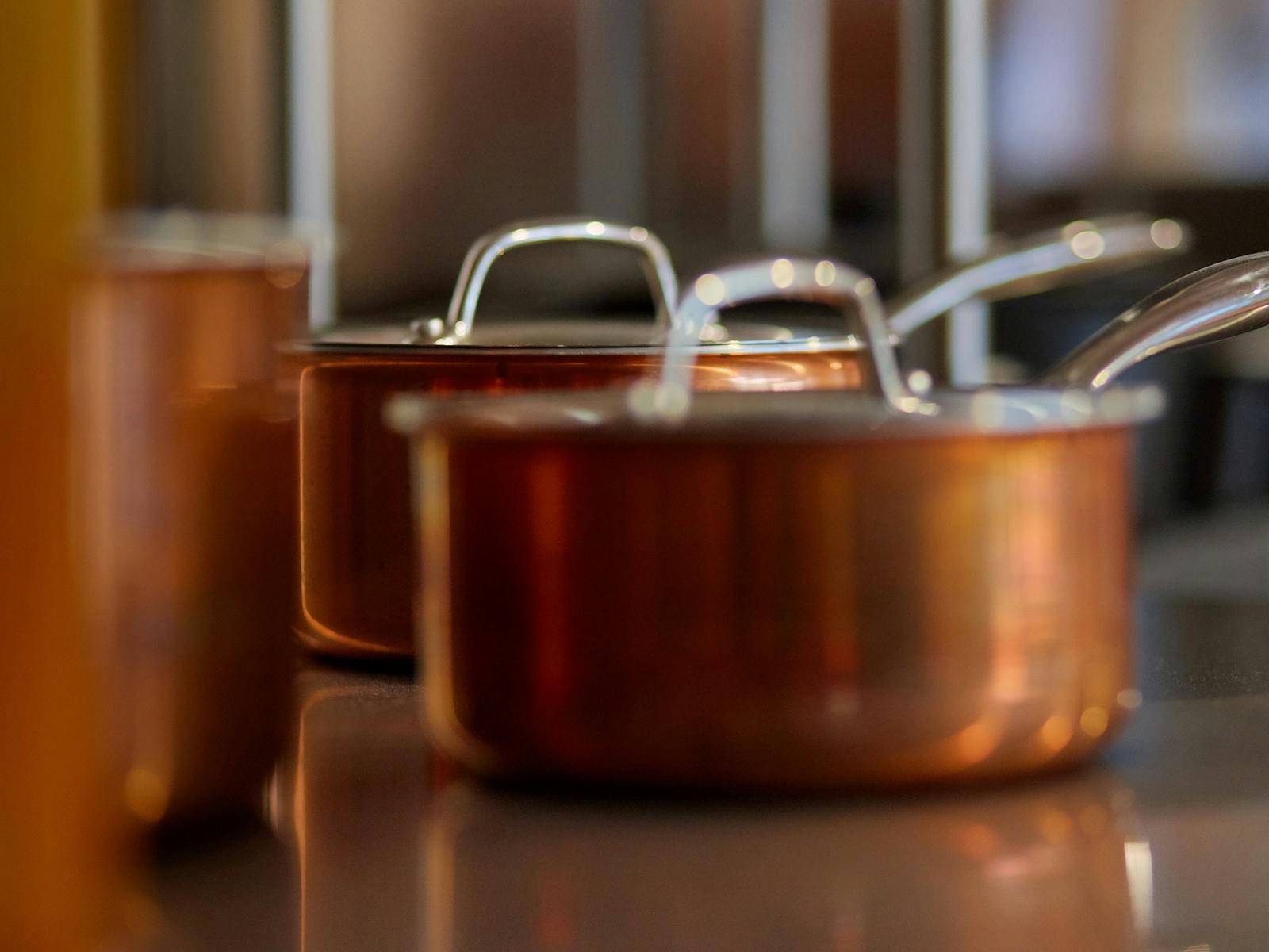 copper cooking pots on shelf