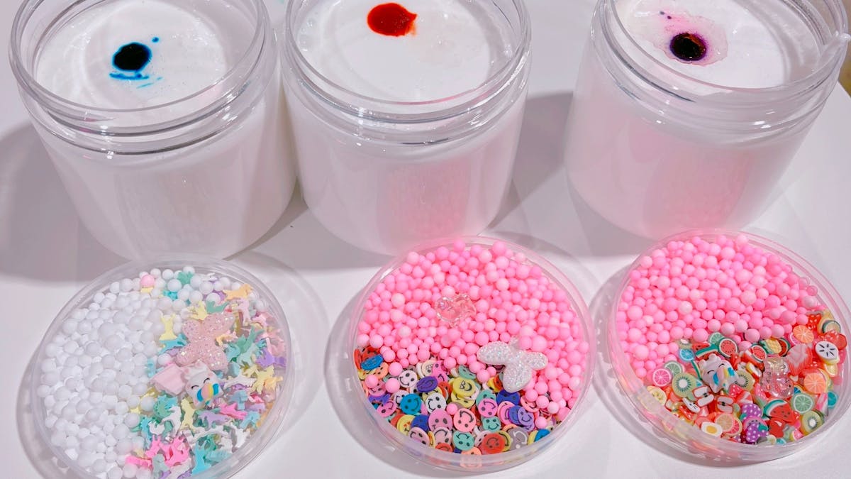 Thick and glossy white slimes with choice of colours , scents, toppings and charms
