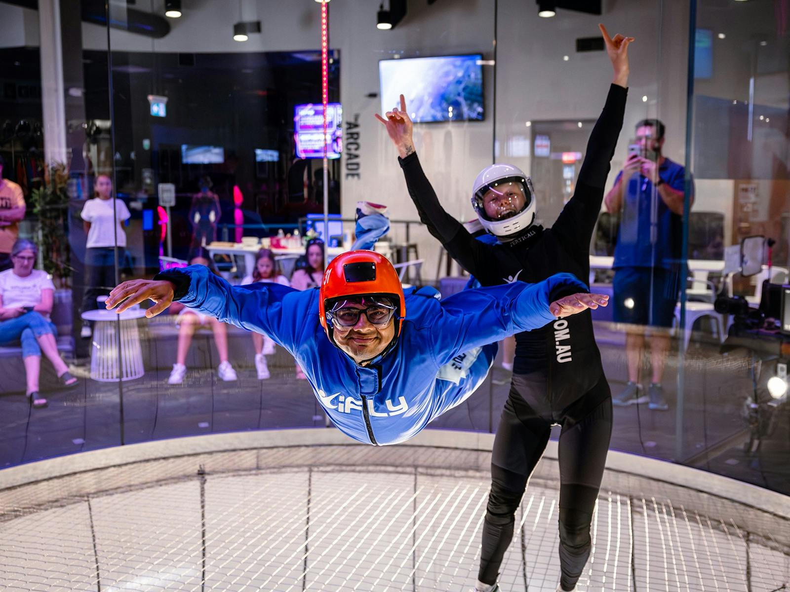 Instructor cheers as happy flyer flies solo.