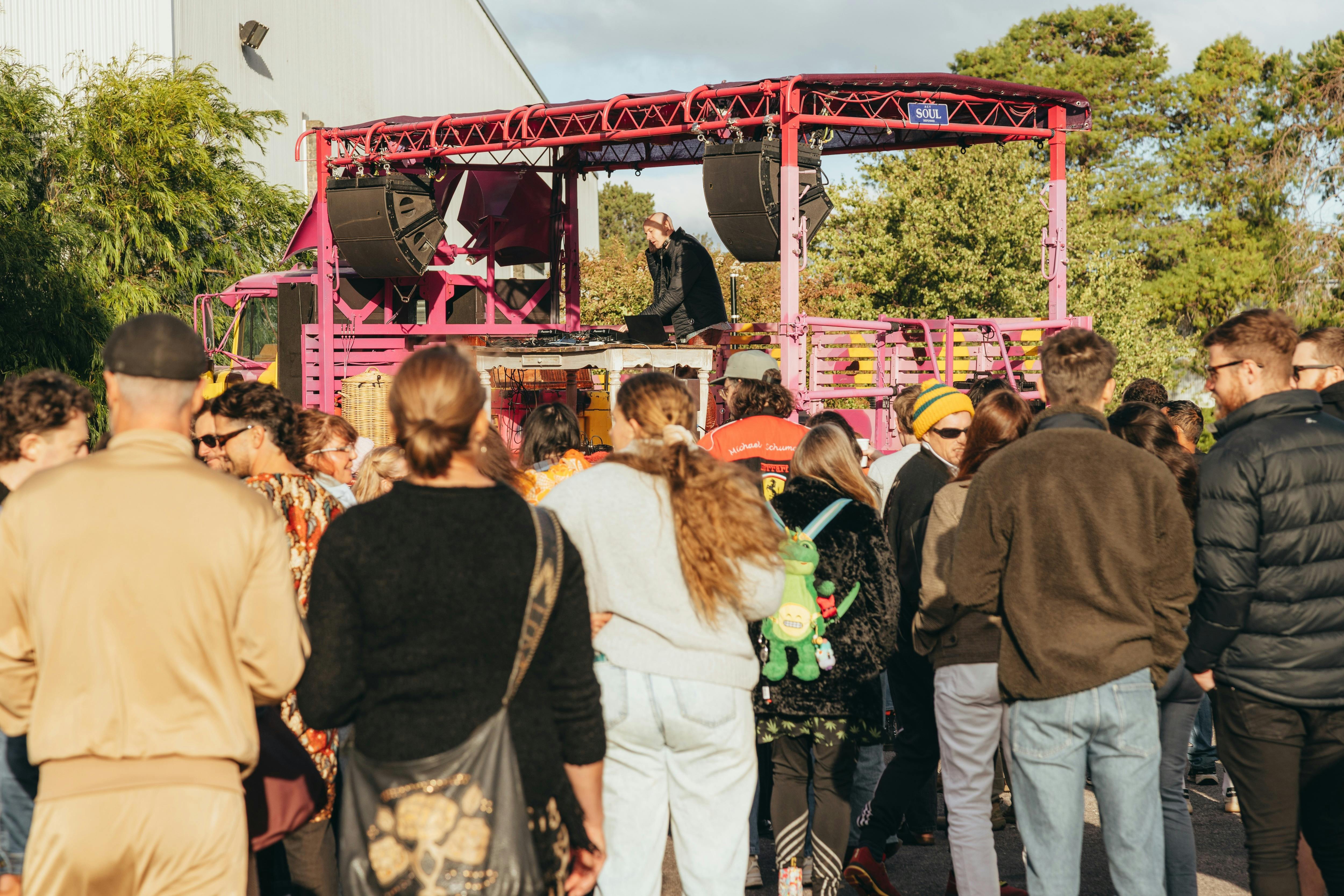 People dancing in the sun to a DJ on the Soul Defender