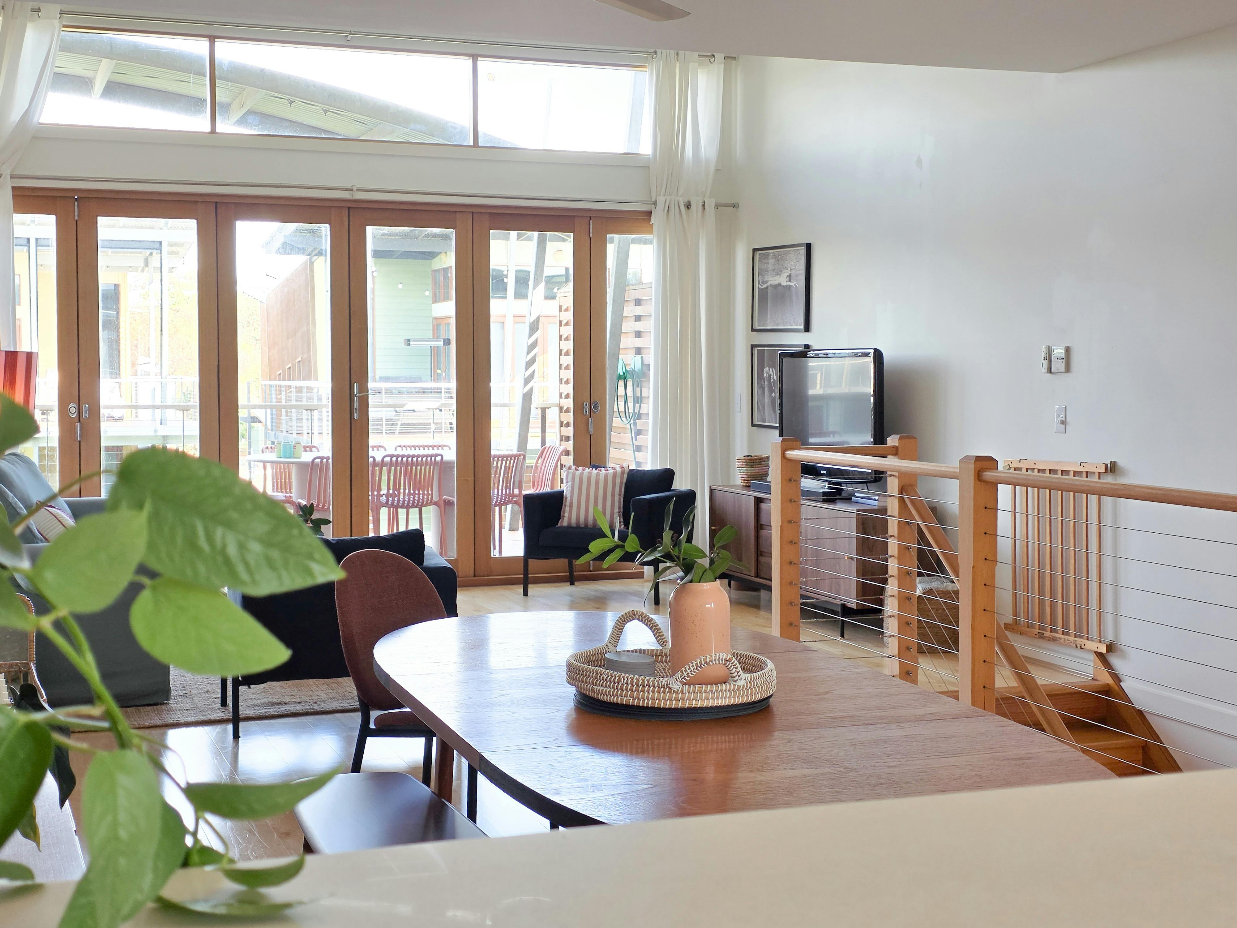 Open-plan kitchen, dining and living space with expansive views stretching through to the lagoon, ke