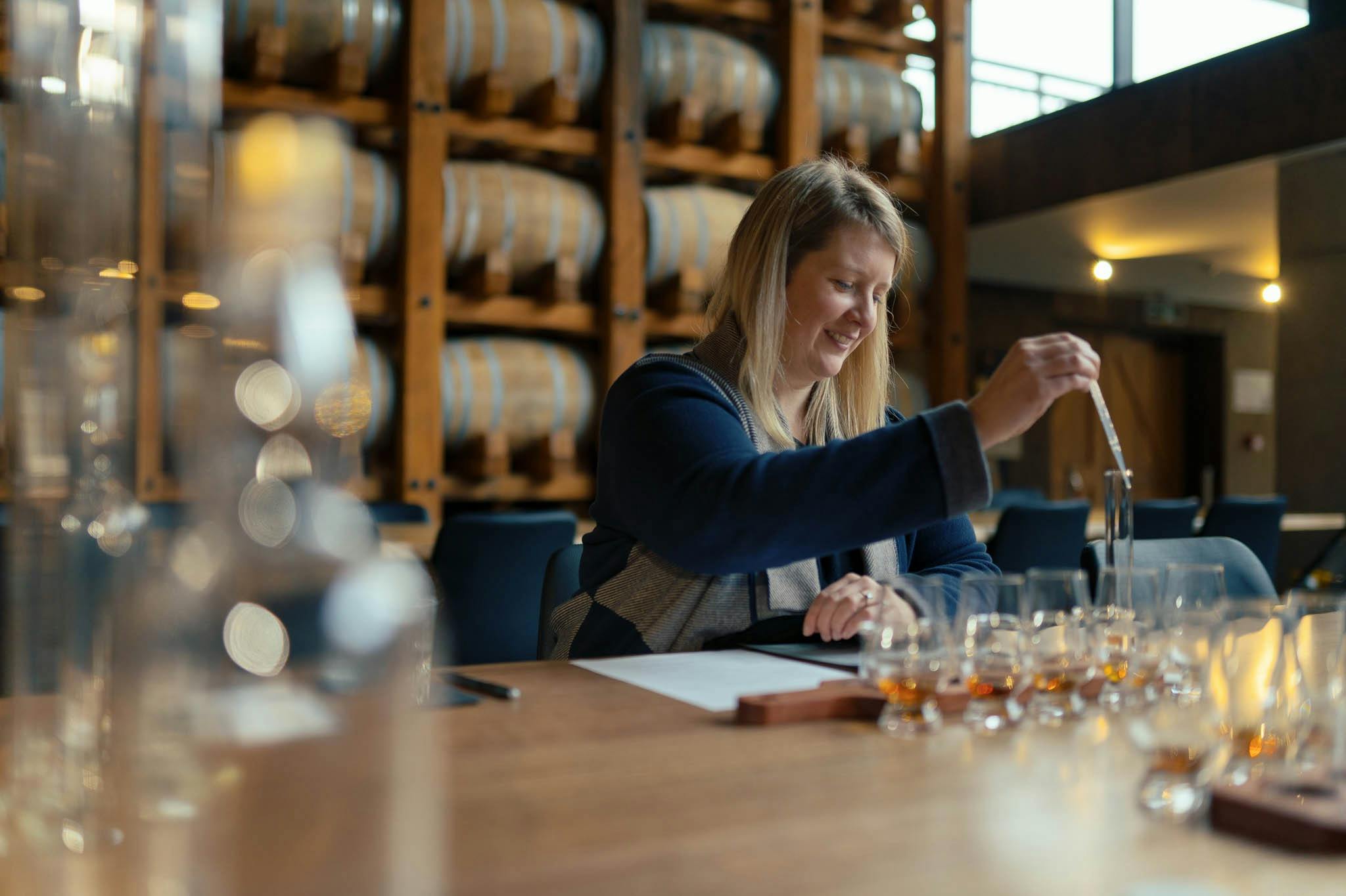 Woman mixing whiskies with dropper