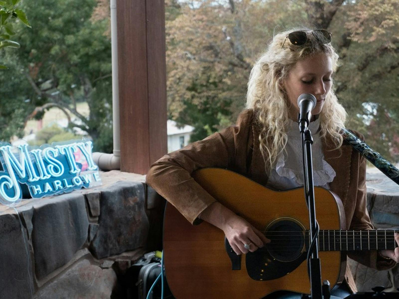 A woman with a guitar singing