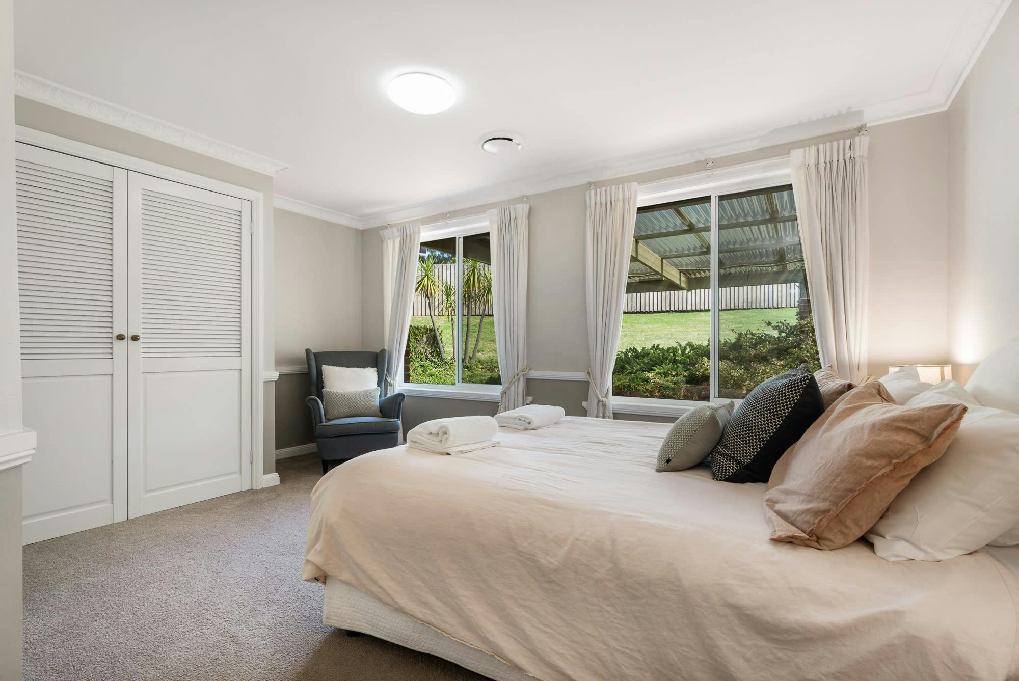 Large bedroom with queen bed and windows